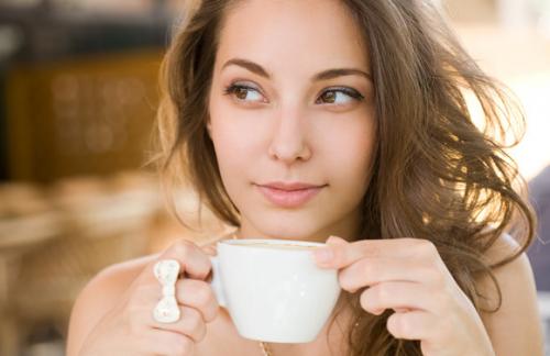 young-brunette-enjoying-cup-of-coffee